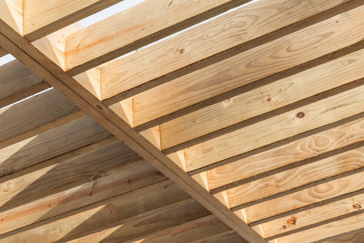 Sunlight filters through wooden garden blinds arranged in a pergola-style design.
